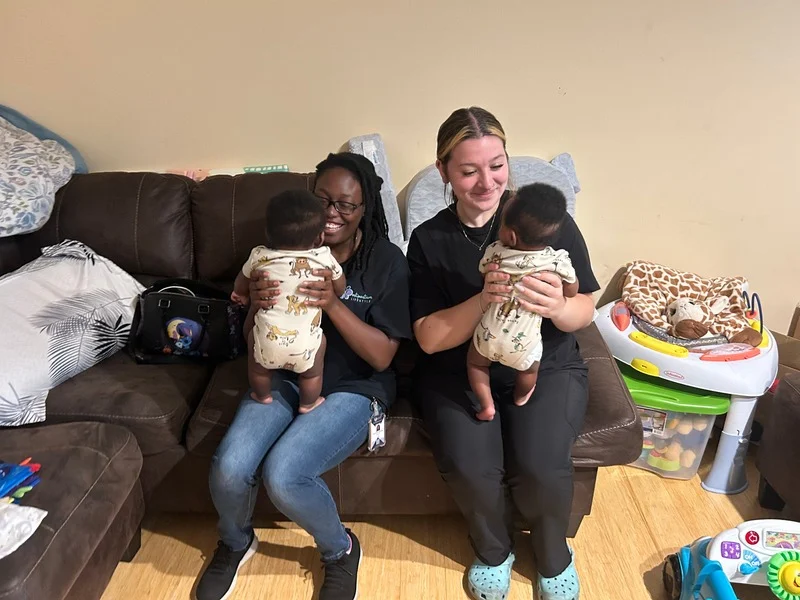 Caregivers spending time with babies